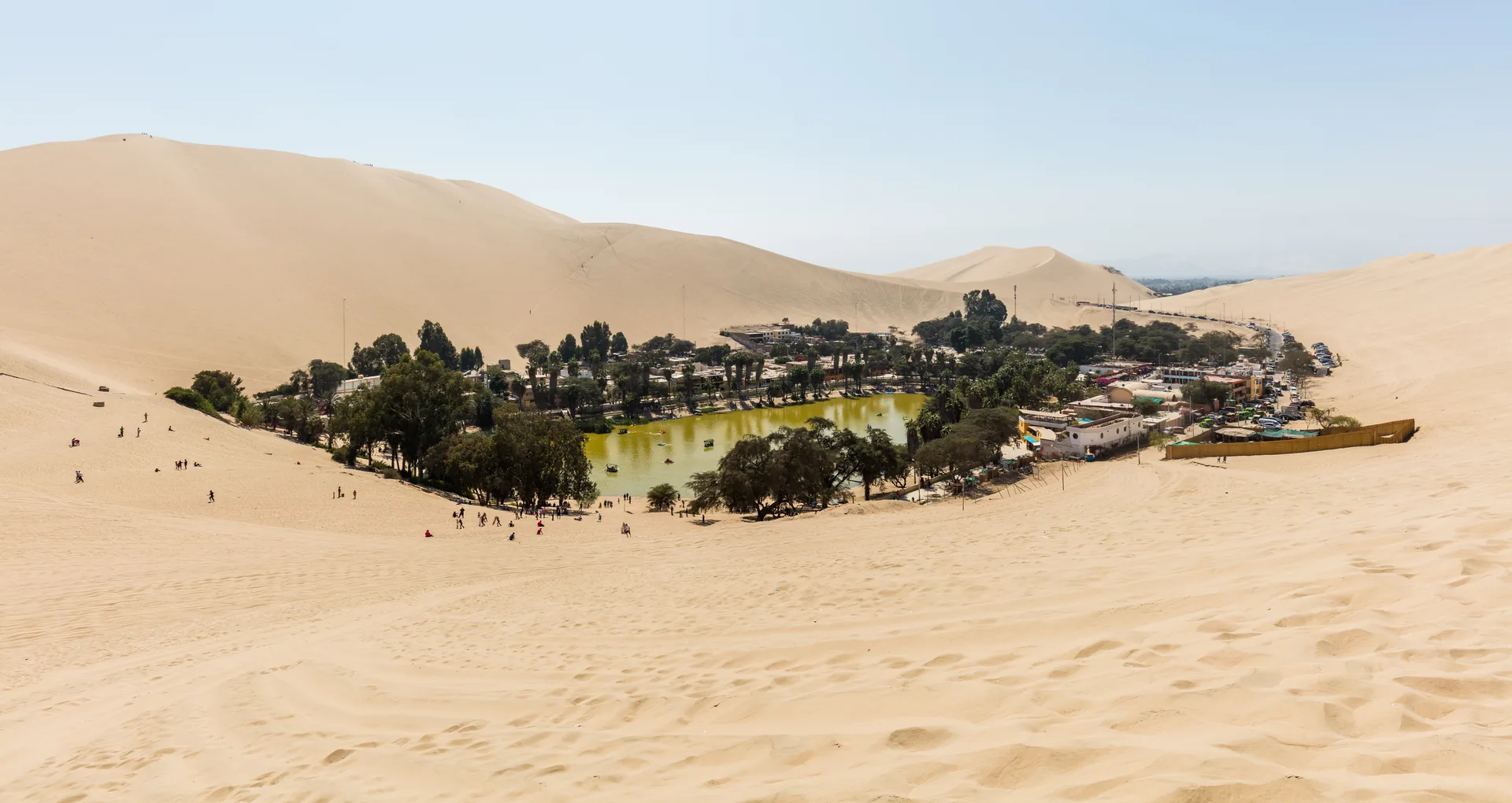 The Huacachina desert oasis ringed by palms and dunes near Ica, Peru